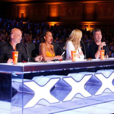 The "America's Got Talent: Season 11" judges (Howie Mandel, Mel B, Heidi Klum and Simon Cowell) share a laugh during a taping of "AGT." (Photo property of NBC)